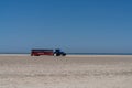 Tractor trailer bringing tourists to the northern tip of Denmark parked on the beach under a blue sky Royalty Free Stock Photo