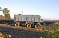 Tractor trailer on farm field in autumn morning Royalty Free Stock Photo