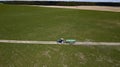 Tractor with trailer fertilizing field with natural manure