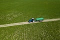 Tractor with trailer fertilizing field with natural manure