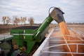 Tractor and trailer offloading corn into a semi Royalty Free Stock Photo