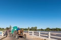 Tractor, trailer with portable toilets crossing Orange River at Marchand