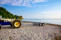 Tractor with trailer for transport boats on the sandy beach Royalty Free Stock Photo