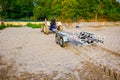 Tractor with trailer for transport boats on the sandy beach Royalty Free Stock Photo
