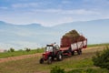 Tractor transporting the gathered grass