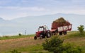 Tractor transporting the gathered grass to the farm