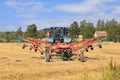 Tractor and Twin Rotary Rake Working in Field