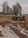 A tractor on twin wheels overcomes a water barrier.