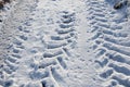 Tractor Tynes tracks in the snow on a road. Royalty Free Stock Photo