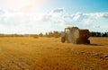 tractor uses trailed bale machine to collect straw in the field and make round large bales. Agricultural work, baling Royalty Free Stock Photo