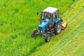 Tractor uses trailed lawn mower to mow grass on city lawns, aerial view Royalty Free Stock Photo