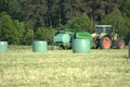 Tractor using a hay bale wrapping machine