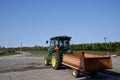 A tractor in the vineyard with rows of wine grapes in the field Royalty Free Stock Photo