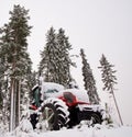 Tractor in winter forest Royalty Free Stock Photo