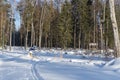 Tractor in the winter forest near the village Royalty Free Stock Photo