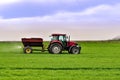 Tractor work on the field. Applying fertilizer in spring