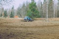 Tractor work on the meadow. Old retro tractor made in USSR Royalty Free Stock Photo