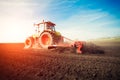 Tractor working on farm land on sunset Royalty Free Stock Photo