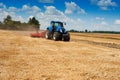 tractor with harrow against a cloudy sky Royalty Free Stock Photo