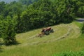 Tractor working in the field. Hay bailing, hay harvesting. Agricultural industry Royalty Free Stock Photo