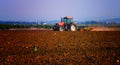 A tractor working in a field with a subsoiler Royalty Free Stock Photo