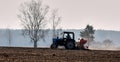 Tractor working in the field. Time of sowing. Planting crops Royalty Free Stock Photo