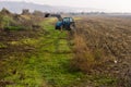 Tractor working in the field on the way to the village of Asparuhovo. Royalty Free Stock Photo