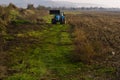 Tractor working in the field on the way to the village of Asparuhovo. Royalty Free Stock Photo