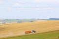 Tractor working Fields of the Pewsey Vale, Wiltshire at harvest Royalty Free Stock Photo