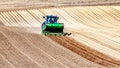 Tractor working on planting potatoes in a field