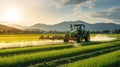 Tractor working on the rice fields barley farm at sunset time, modern agricultural transport Royalty Free Stock Photo