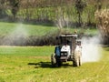 Tractor working spreading fertiliser