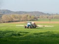 Tractor working spreading fertiliser