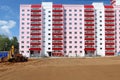 Tractor works near new building on construction site