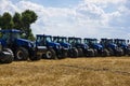 Tractors in the field, aligned in a row