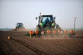 Tractors laying seeds on field