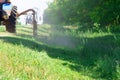 Tractors machines mowing lawn grass along road Royalty Free Stock Photo