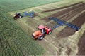 Tractors with plow on soil cultivating. tractor bowling field, drone view. Cultivated plant soil tillage. Agricultural Royalty Free Stock Photo