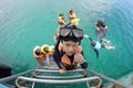 Trad,Thailand-March 20,2018:Tourists up to the boat using stainless steel ladder after snorkeling at Kon Chang
