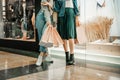 Trade, buyers. Two beautiful girls make purchases in a shopping center, go shopping. The joy of consumption.