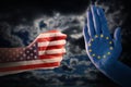 Trade conflict, fist with USA flag against a hand with European