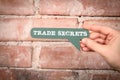 Trade Secrets. Green speech bubble with text on a red brick background Royalty Free Stock Photo