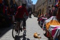 Cyclist on a trade street, Essaouira, Morocco
