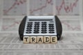 Trade word with calculator on business newspaper Royalty Free Stock Photo