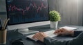 Trader analyzing stock market data on computer at office desk Royalty Free Stock Photo