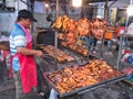 A trader cooks kebab skewers of meat over hot coals to sell as freshly cooked, hot, street food in Phnom Penh, Cambodia