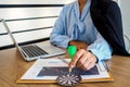 Trader woman holding a darts aiming at the target center of dart board, Setting challenging trading  goals And ready to achieve Royalty Free Stock Photo