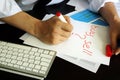 Trader is writing buy or sell in a note. Royalty Free Stock Photo