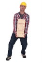 Tradesman carrying a heavy bricks Royalty Free Stock Photo
