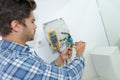 Tradesman fixing electrical issue with hand dryer